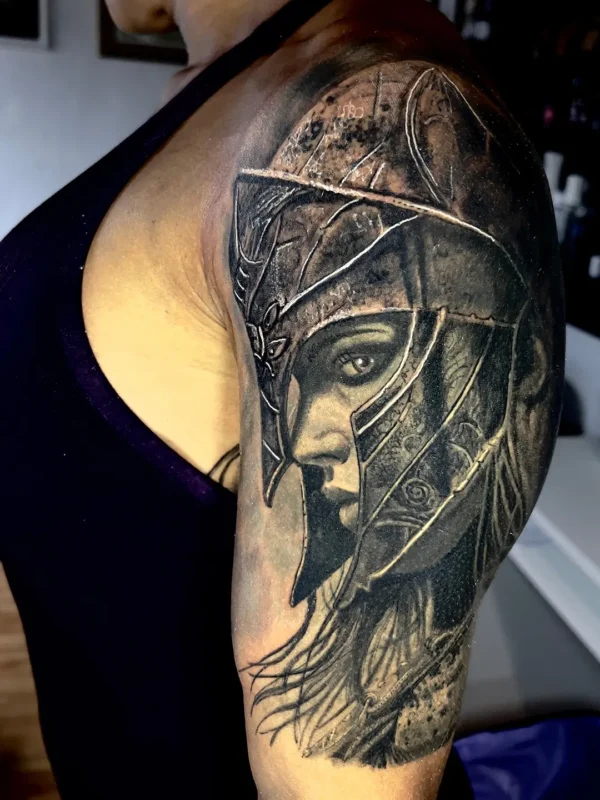 Tatuaje de casco espartano (estilo superrealista) en el hombro